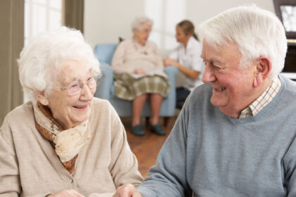 An older man and woman laughing together