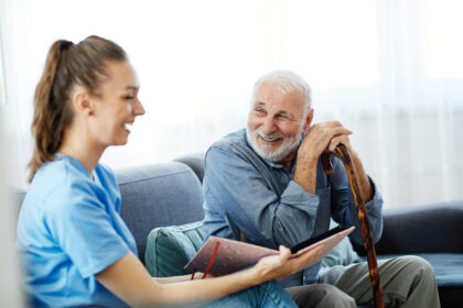 Nurse and older man smiling